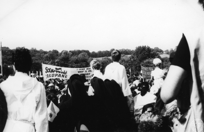 Widoczne są flagi i transparenty trzymane przez zgromadzonych ludzi, po lewej transparent z logo „Solidarność Zakopane”